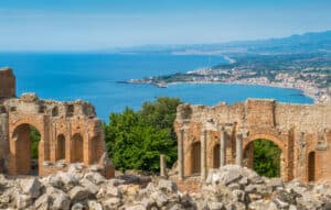 Ruins of the Ancient Greek Theater in Taormina with the sicilian coastline. Province of Messina, Sicily, southern Italy