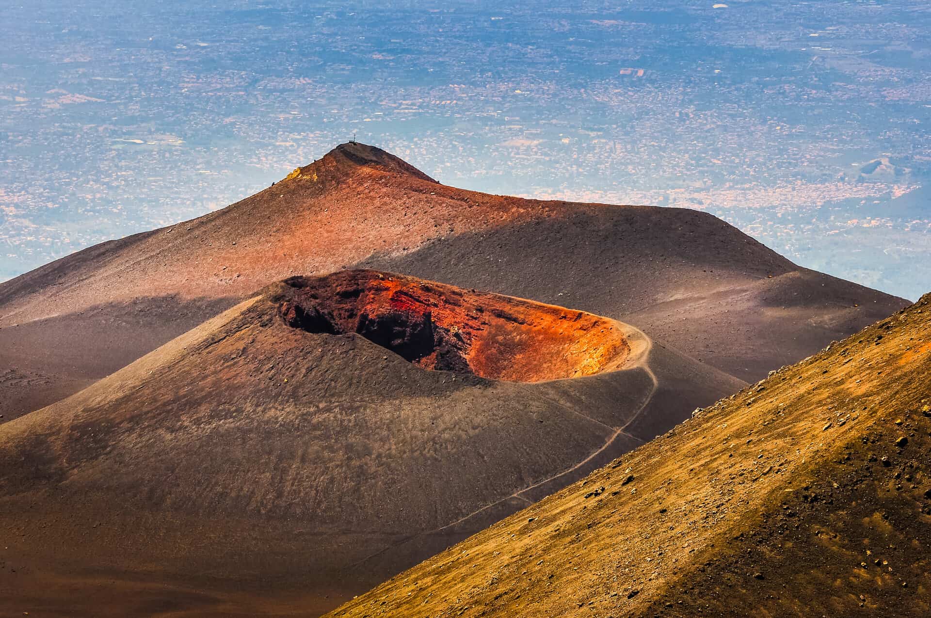 Colorful crater of Etna volcano with Catania in background, Sicily, Italy